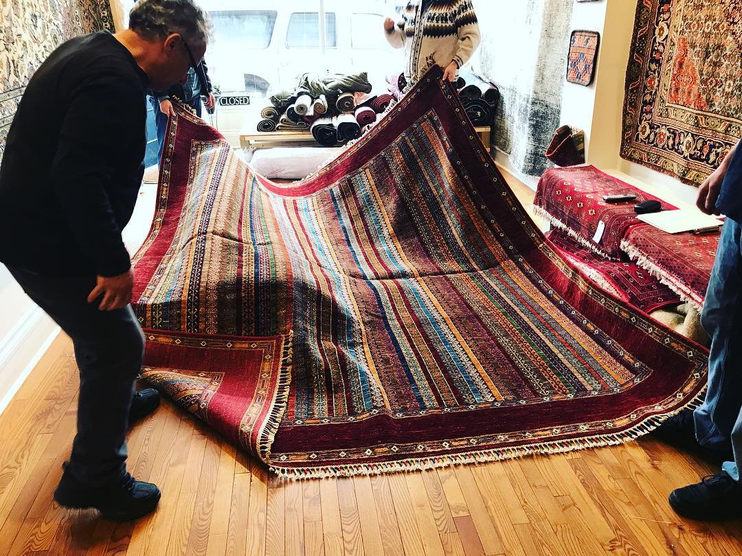 3 men working at the rug shop
